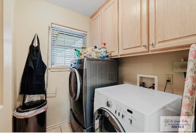 laundry room with cabinets and separate washer and dryer