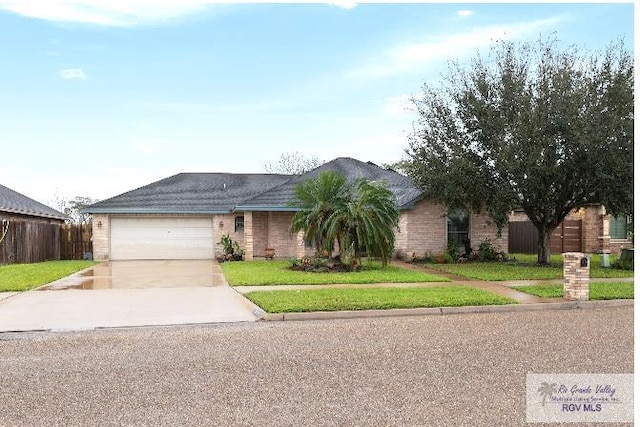 ranch-style home with a garage and a front lawn