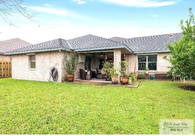 back of property featuring a yard and a patio