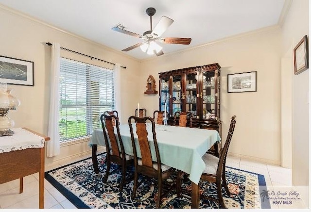 tiled dining space featuring ceiling fan and crown molding