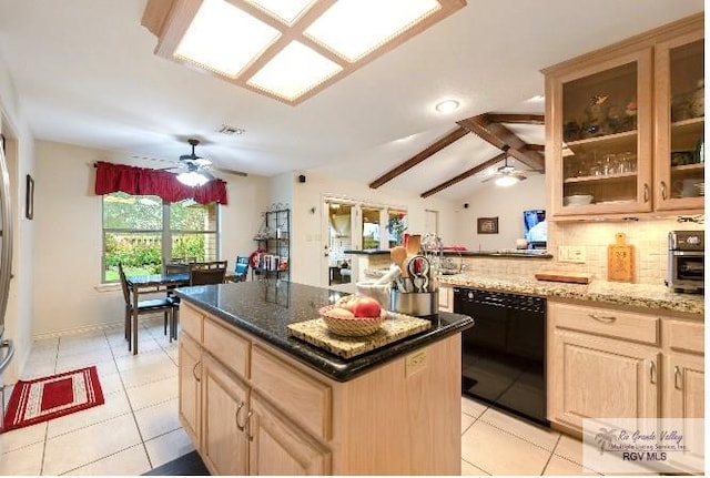 kitchen with a center island, light brown cabinets, black dishwasher, tasteful backsplash, and light stone counters