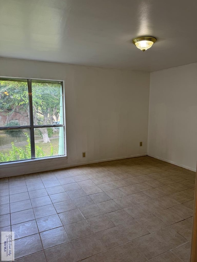 spare room featuring light tile patterned floors