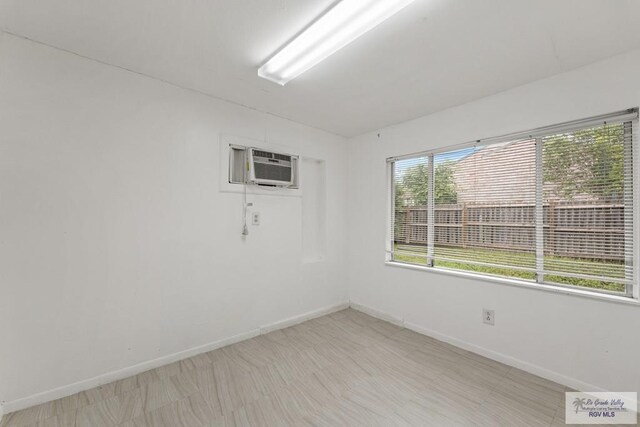 unfurnished room with a wall mounted air conditioner