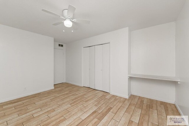 unfurnished bedroom featuring ceiling fan, light hardwood / wood-style floors, and a closet