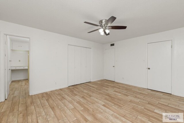 unfurnished bedroom with ceiling fan and light wood-type flooring