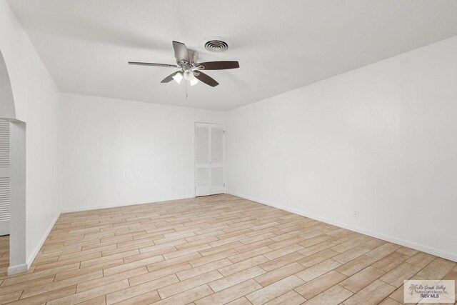 empty room featuring ceiling fan and light hardwood / wood-style flooring