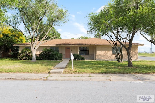 ranch-style home with a front lawn