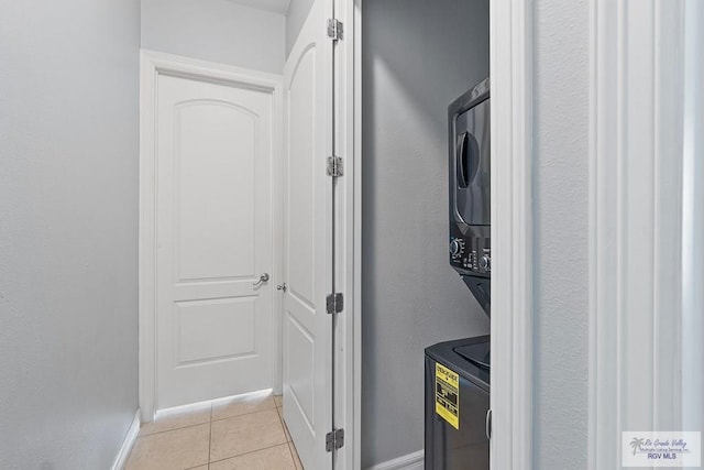 131 E Saturn Ln, South Padre Island, TX 78597 - hallway with stacked washer / drying machine and light tile patterned floors