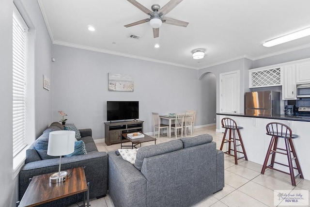 131 E Saturn Ln, South Padre Island, TX 78597 - living area with a ceiling fan, light tile patterned flooring, ornamental molding, arched walkways, and recessed lighting