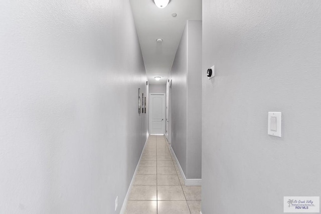 131 E Saturn Ln, South Padre Island, TX 78597 - hall with light tile patterned flooring and baseboards