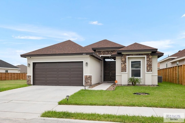 view of front of property with a front yard and a garage