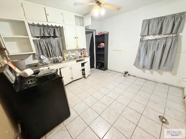 kitchen featuring white cabinetry, ceiling fan, and light tile patterned flooring