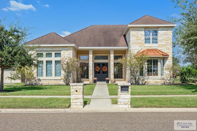 view of front of property with french doors, a front lawn, and covered porch