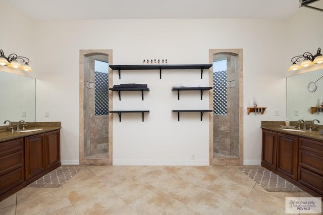 bathroom featuring vanity, a healthy amount of sunlight, and a tile shower