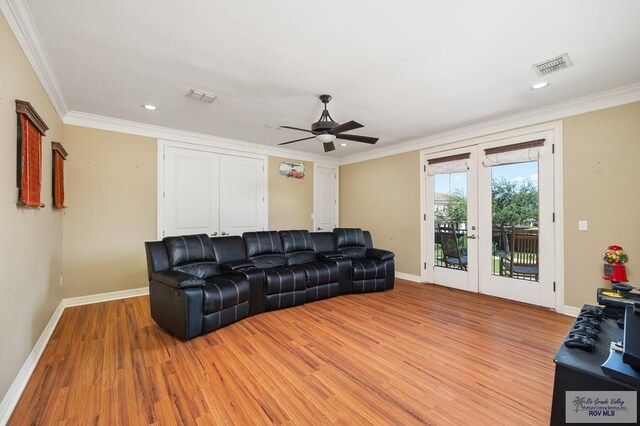 living room with ceiling fan, light hardwood / wood-style floors, crown molding, and french doors