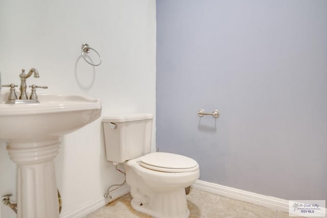 bathroom with tile patterned floors and toilet