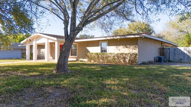 ranch-style house with central air condition unit and a front lawn