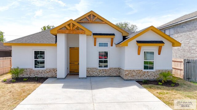 2708 Naples St, Brownsville, TX 78520 - view of front of property with stone siding, stucco siding, and roof with shingles