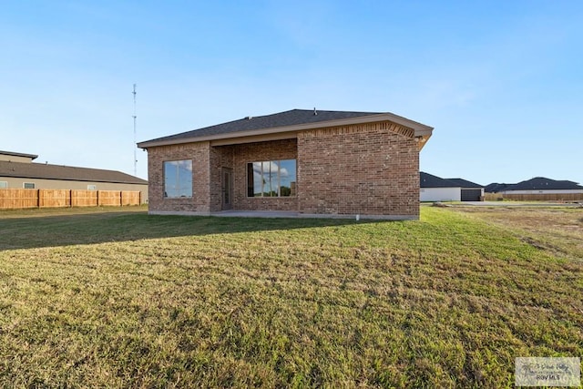 back of house featuring a yard