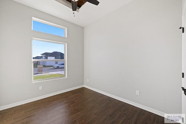 empty room with dark hardwood / wood-style floors and ceiling fan