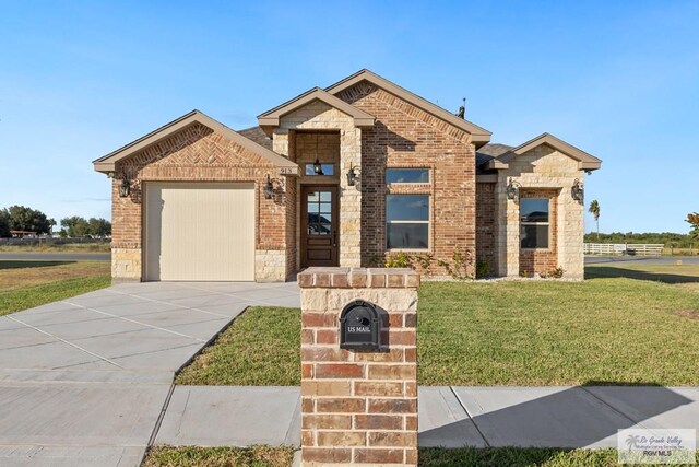 view of front of home with a garage and a front lawn