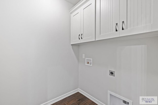 washroom featuring hookup for an electric dryer, dark hardwood / wood-style floors, cabinets, and hookup for a washing machine