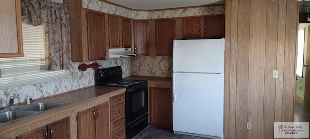 kitchen with black electric range, decorative backsplash, white refrigerator, and sink