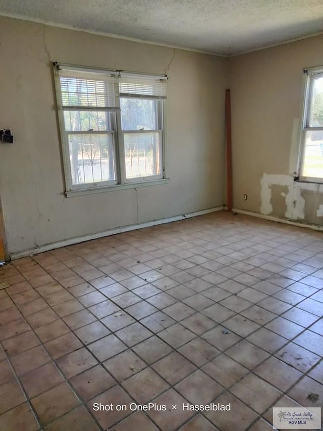 spare room with a textured ceiling