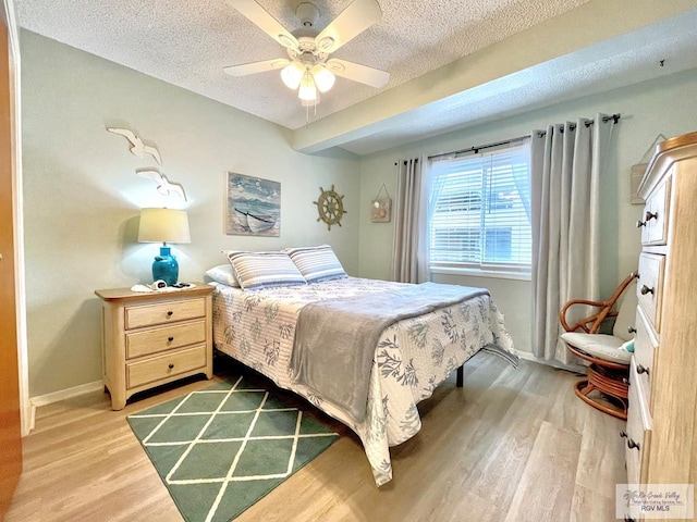 bedroom featuring a textured ceiling, ceiling fan, and hardwood / wood-style flooring