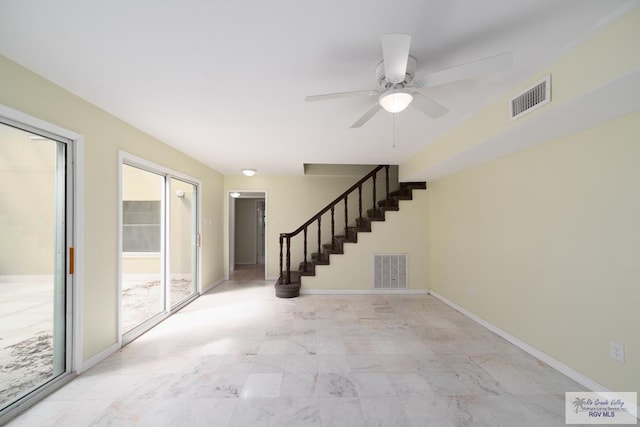 empty room featuring visible vents, baseboards, and stairs