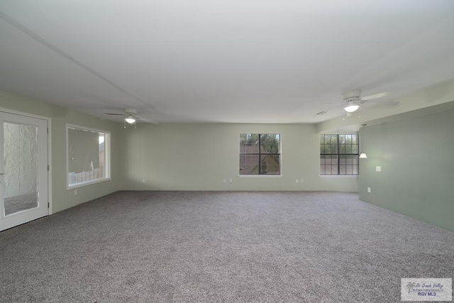 carpeted empty room featuring a ceiling fan