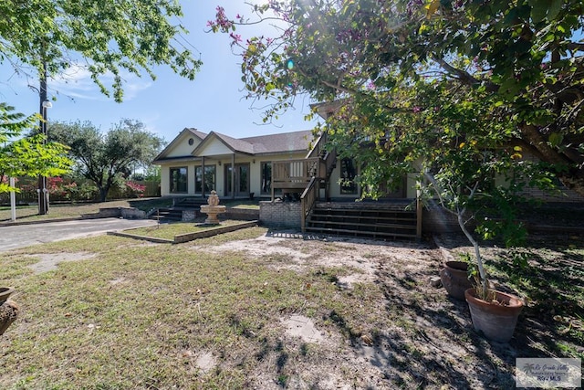 back of house with a lawn