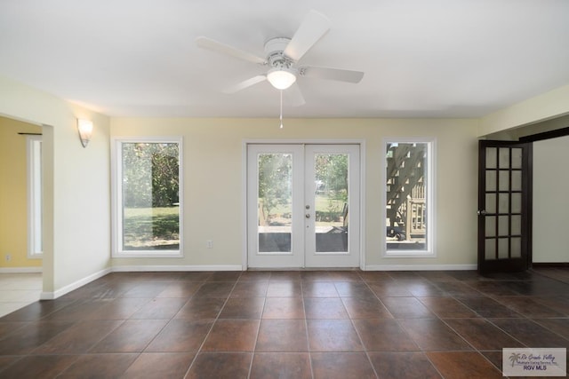 interior space featuring french doors, a healthy amount of sunlight, ceiling fan, and baseboards