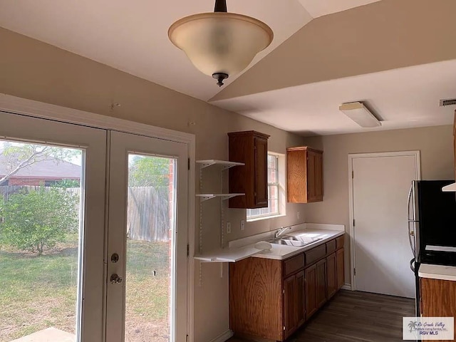 kitchen with light countertops, a healthy amount of sunlight, french doors, and a sink