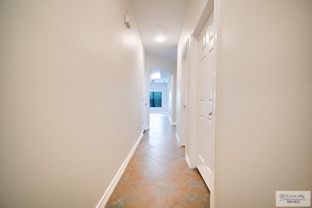 corridor featuring light tile patterned floors