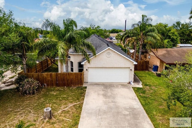 view of front of home featuring a front yard and a garage