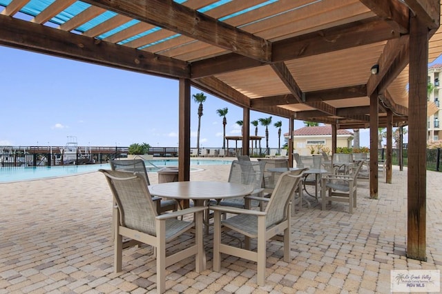 301 Houston Ave Unit 3402, Port Isabel, TX 78578 - view of patio / terrace with a community pool, a pergola, and outdoor dining space