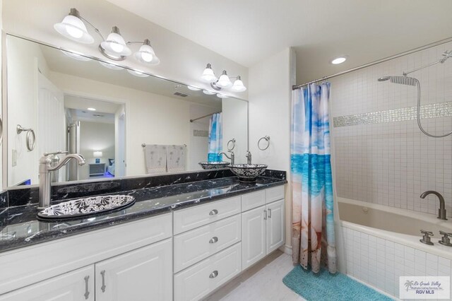 301 Houston Ave Unit 3402, Port Isabel, TX 78578 - bathroom featuring tiled shower / bath combo, double vanity, and recessed lighting