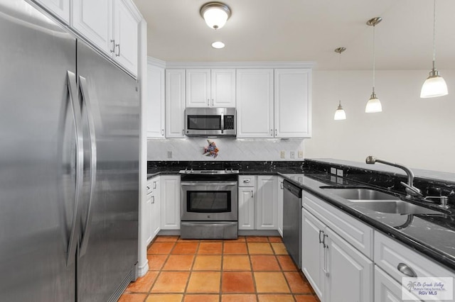 301 Houston Ave Unit 3402, Port Isabel, TX 78578 - kitchen with stainless steel appliances, white cabinetry, backsplash, and pendant lighting