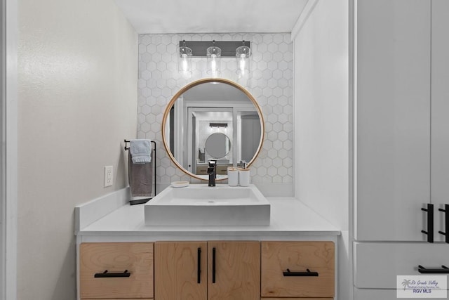 bathroom featuring vanity and backsplash