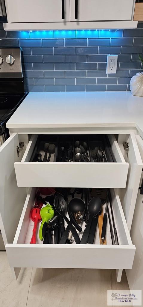 details with backsplash and stainless steel electric range oven