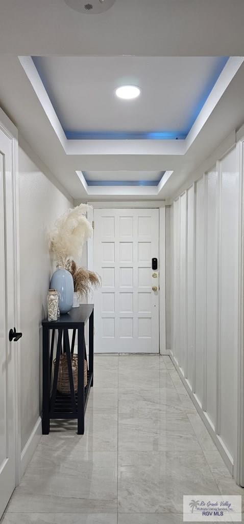 corridor featuring a tray ceiling