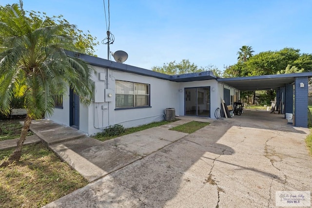 back of property featuring a carport