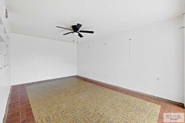 empty room featuring ceiling fan and a textured ceiling