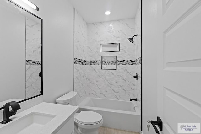 full bathroom featuring vanity, toilet, and tiled shower / bath