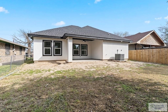 rear view of house featuring a patio, a yard, central AC, and ceiling fan