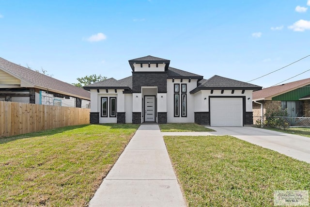 view of front facade featuring a garage and a front lawn