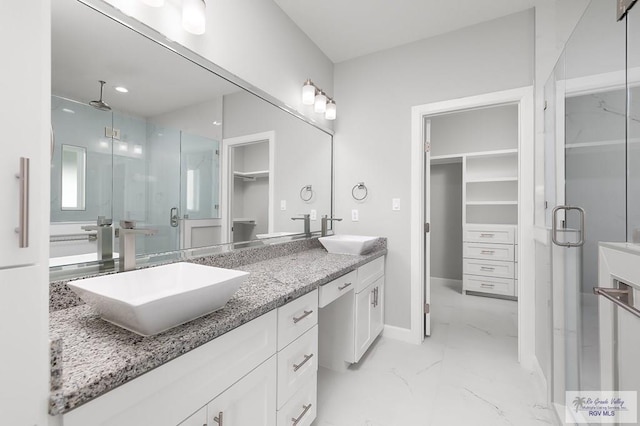 bathroom featuring vanity and a shower with shower door