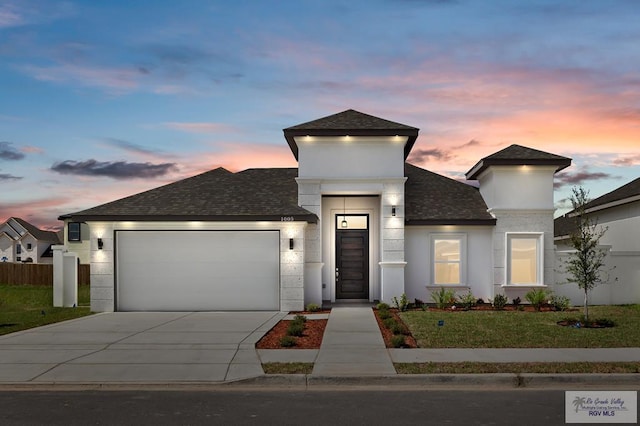 view of front facade featuring a yard and a garage