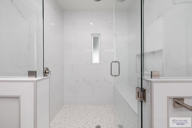 bathroom with a shower with door